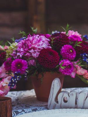 Celebratory table is decorated with compositions of flowers. Original wedding floral decoration on wedding table